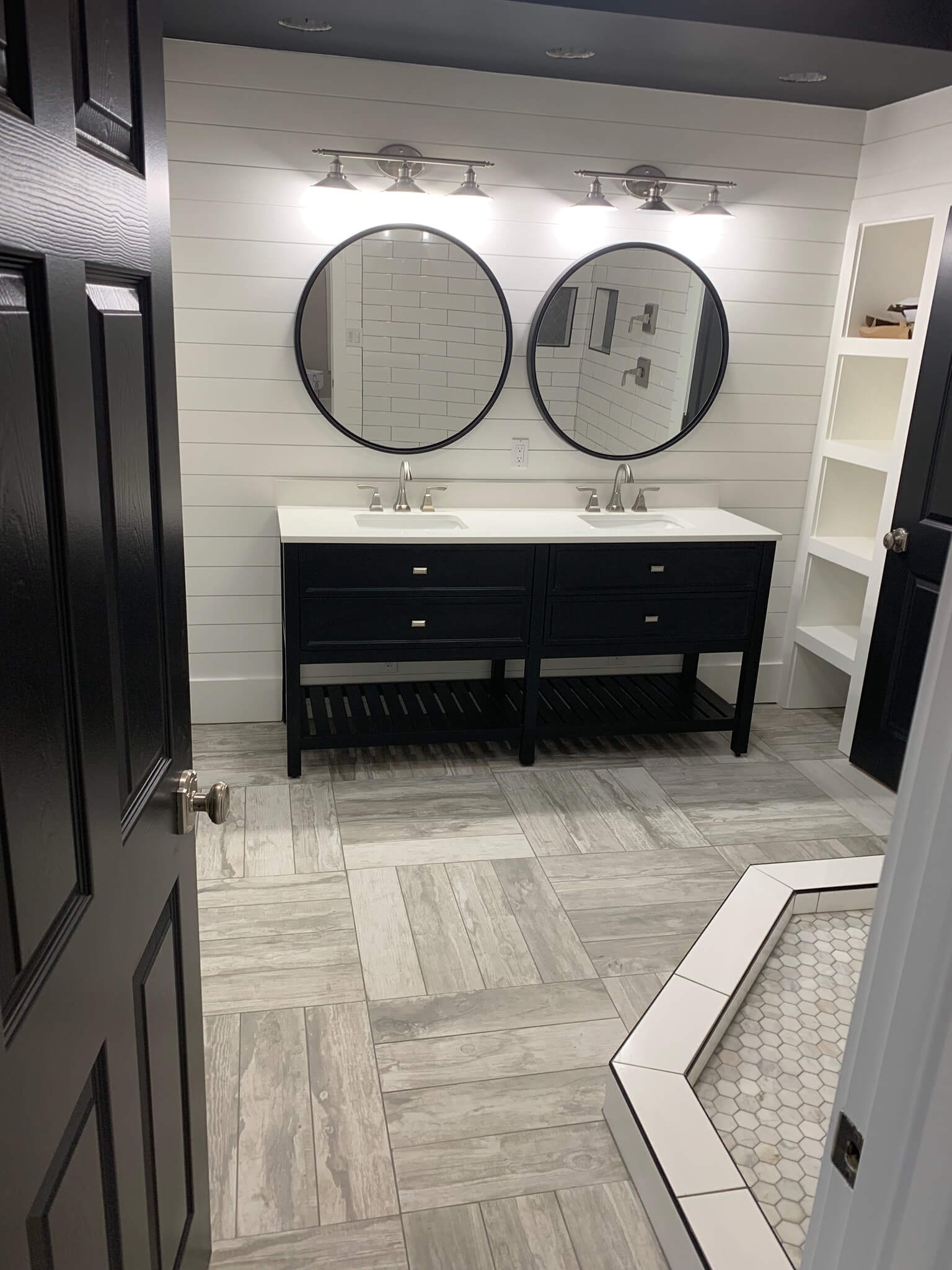 Custom bathroom with sink, mirrors, and cabinetry