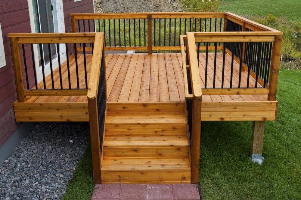 Wooden deck with stairs and railing, great for outdoor entertaining