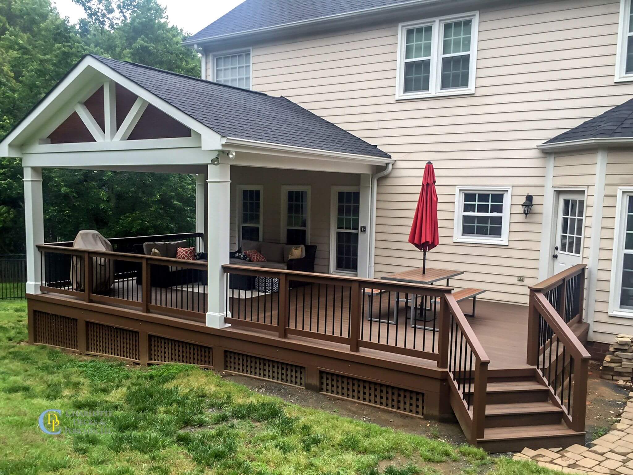 Covered porch with wooden deck and stone patio