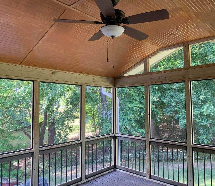 Sunroom with ceiling fan and wooden deck